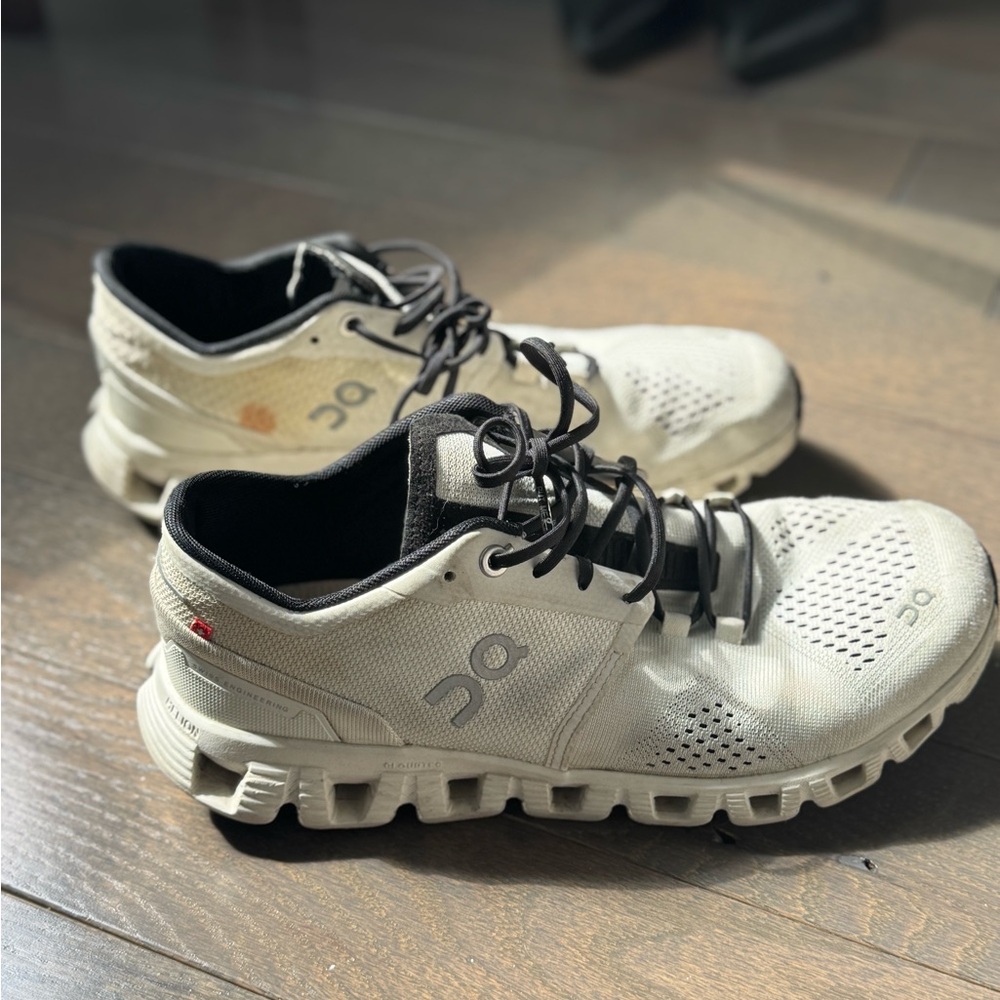 On Running White and Black Athletic Shoes with Cloud-Like Sole